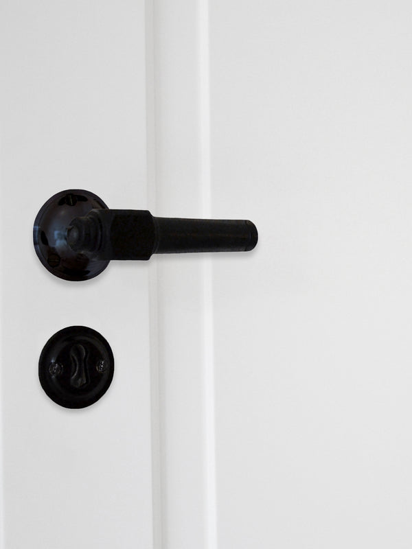 Svankvarns dörrhandtag i svart bok med släta rosetter och nyckelskyltar